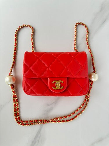 Chanel Red Quilted Flap Bag with Pearl-Embellished Chain Strap.