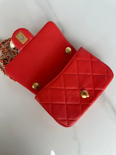 Chanel Red Quilted Flap Bag with Pearl-Embellished Chain Strap.