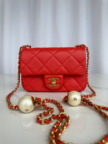 Chanel Red Quilted Flap Bag with Pearl-Embellished Chain Strap.