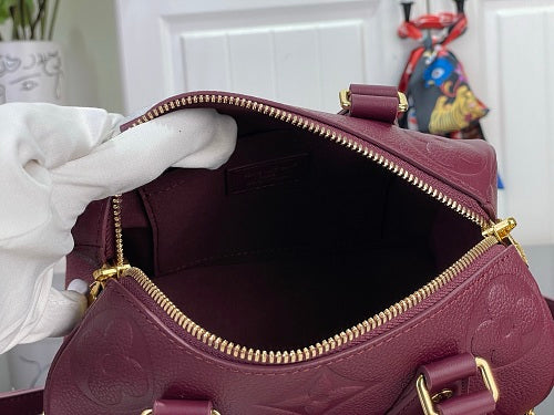 Louis Vuitton Speedy Bandoulière 20 Monogram Empreinte Leather in a Grenat